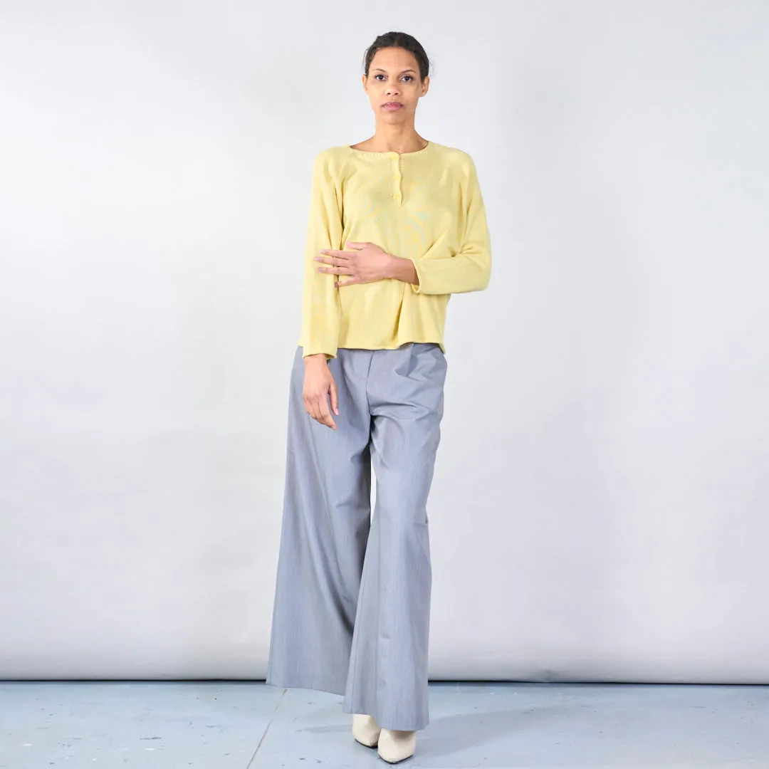 Knit top with button detail and wavy hem wholesale